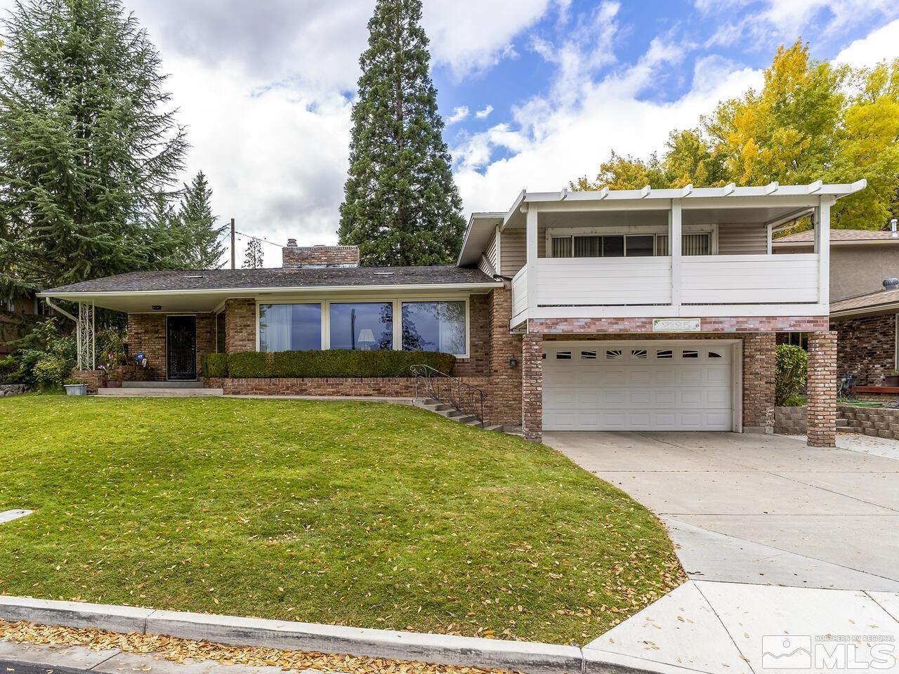 2125 Lakeside Drive Reno, NV 89509 - Photo 1 of 33 a front view of a house with a garden