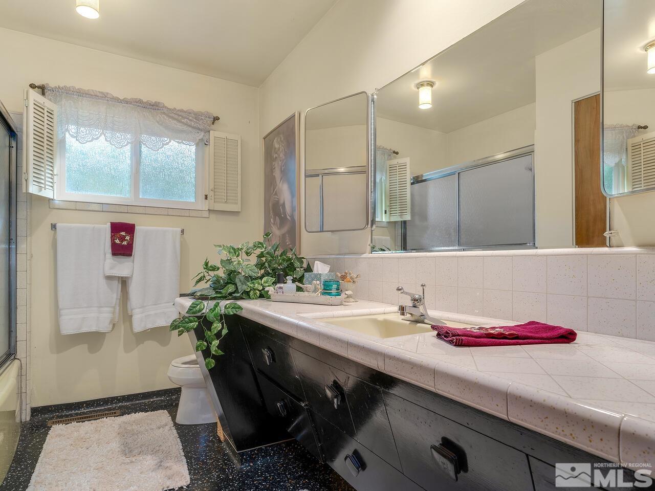 2125 Lakeside Drive Reno, NV 89509 - Photo 19 of 33 a bathroom with a sink and a mirror