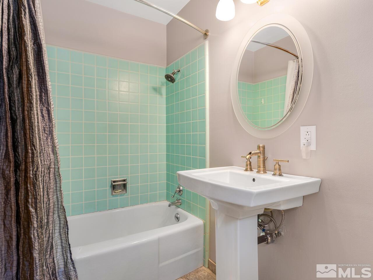 2125 Lakeside Drive Reno, NV 89509 - Photo 21 of 33 a bathroom with a sink a bathtub and a mirror