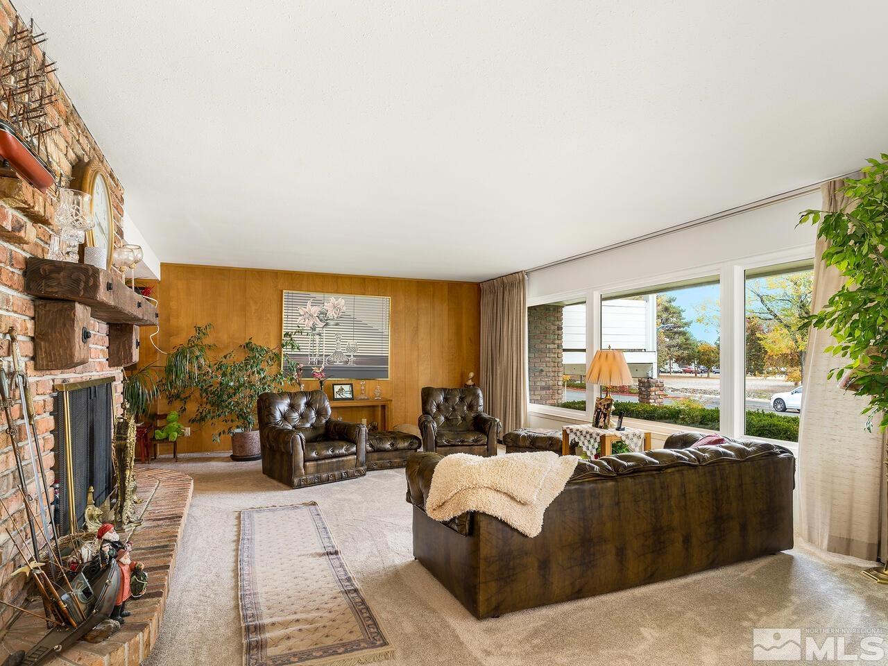 2125 Lakeside Drive Reno, NV 89509 - Photo 4 of 33 a living room with furniture large windows and a fireplace