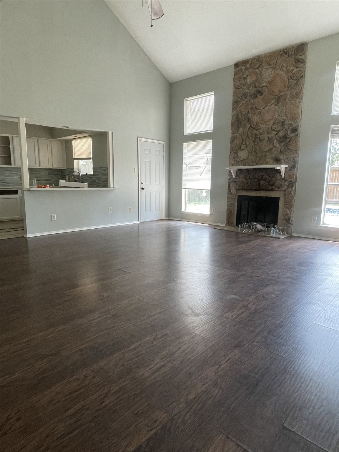 3443 Nutwood Lane Spring, TX 77389 - Photo 3 of 8 an empty room with wooden floor fireplace and windows