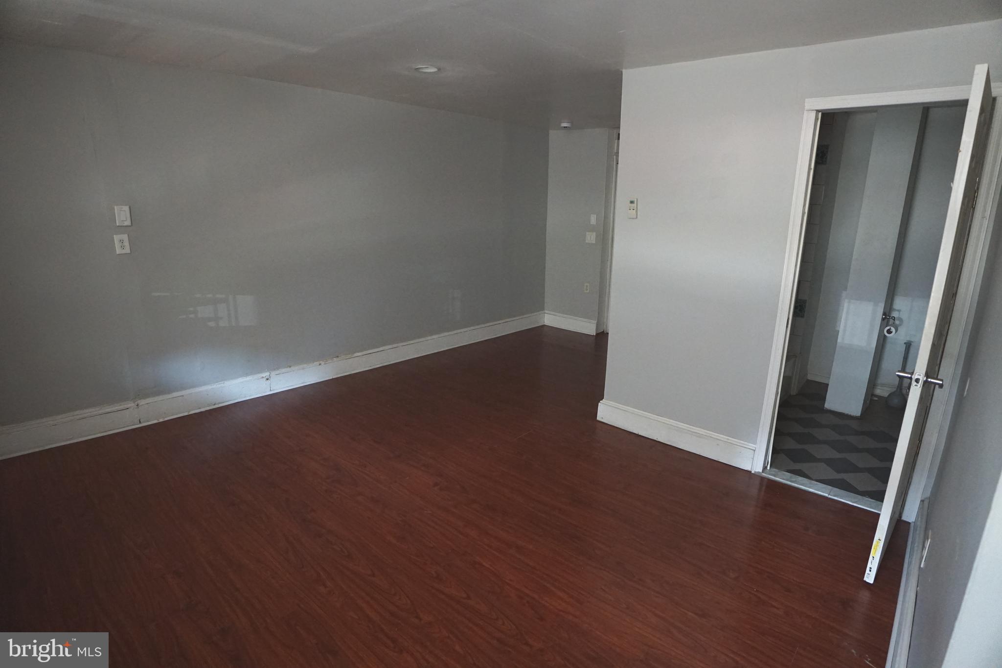 804 Cathedral Street, Unit 7 Baltimore, MD 21201 - Photo 12 of 22 an empty room with wooden floor and entrance