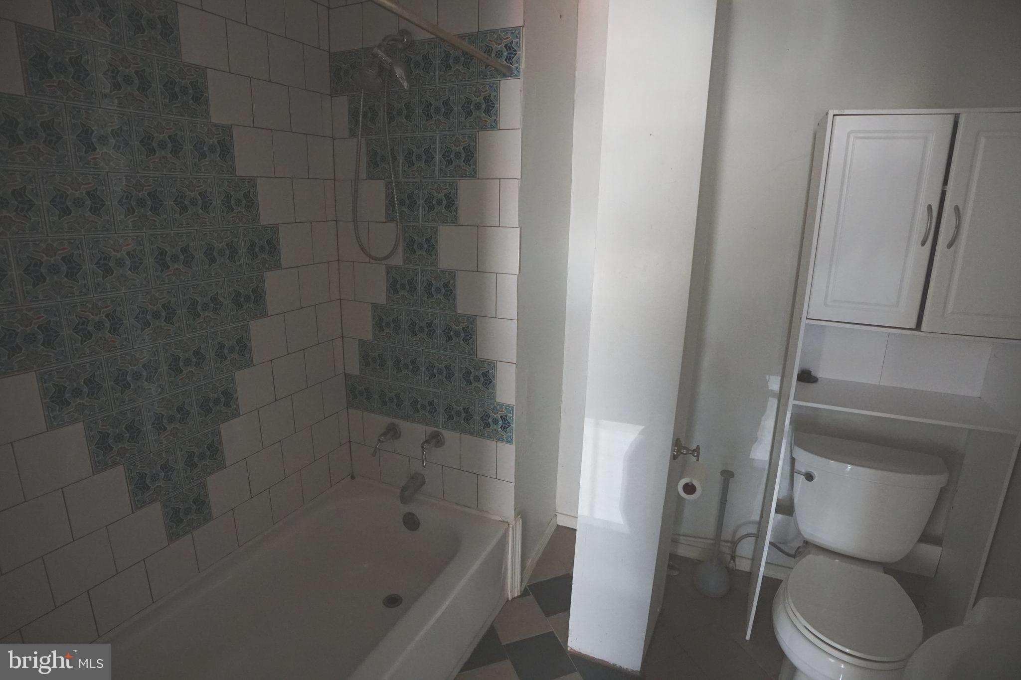 804 Cathedral Street, Unit 7 Baltimore, MD 21201 - Photo 13 of 22 a bathroom with a bathtub and a toilet