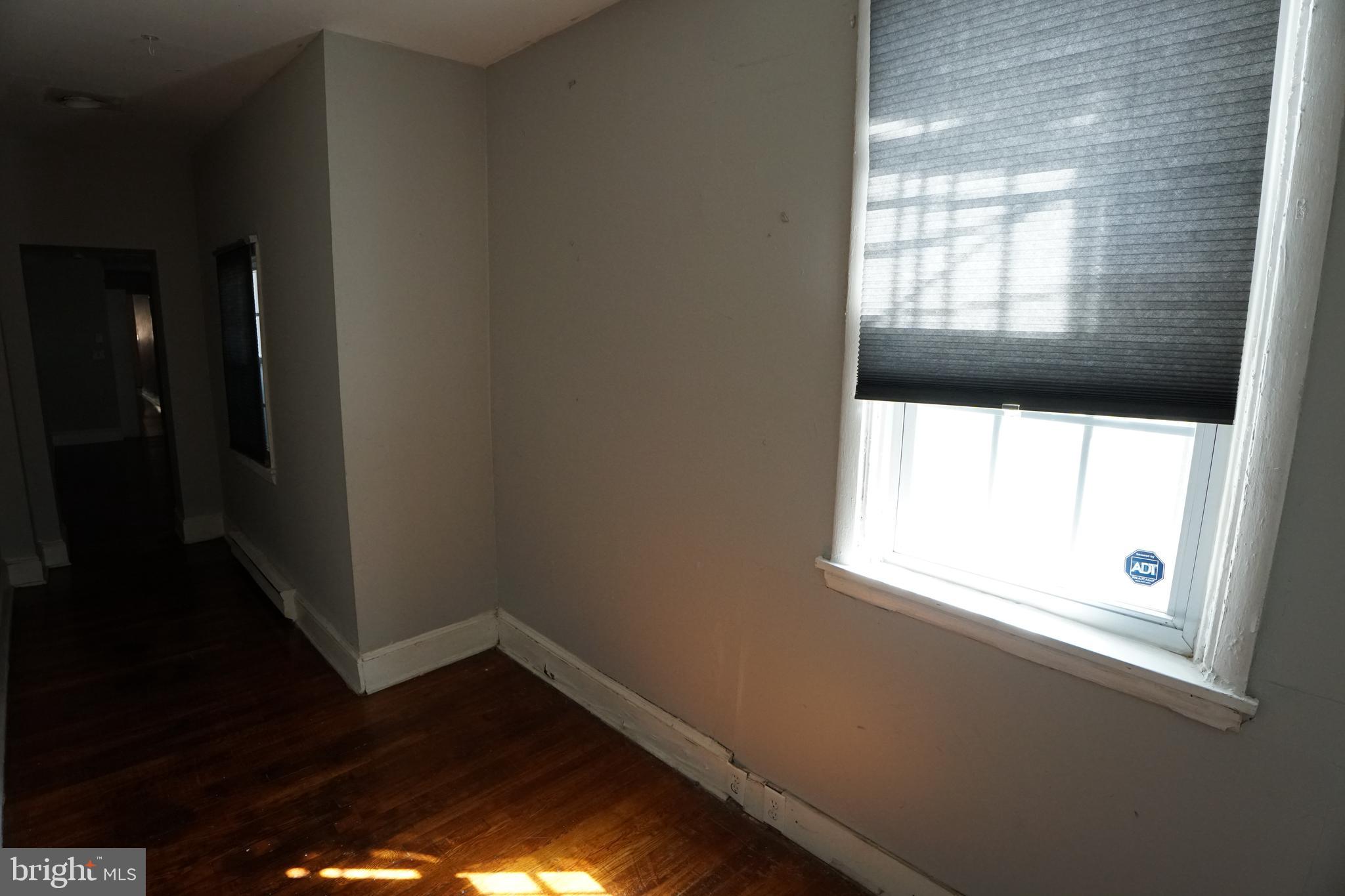804 Cathedral Street, Unit 7 Baltimore, MD 21201 - Photo 16 of 22 a view of empty room with wooden floor and fan