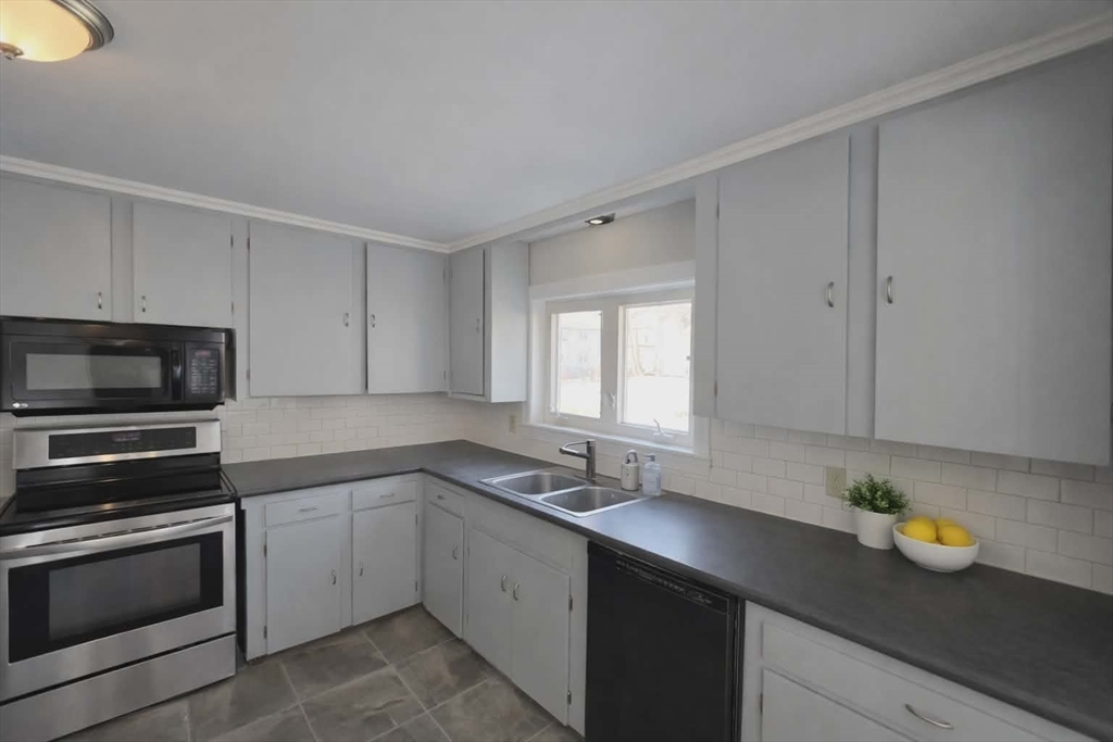 171 Mendon Road Attleboro, MA 02703 - Photo 2 of 11 a kitchen with a sink stove and microwave