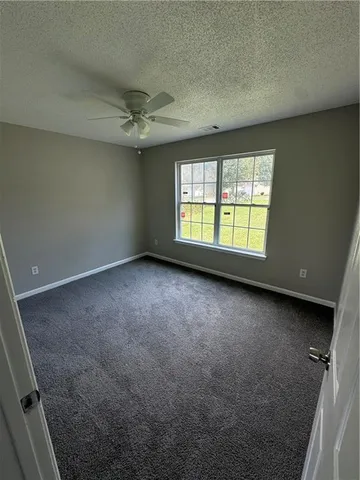 an empty room with a empty space and windows
