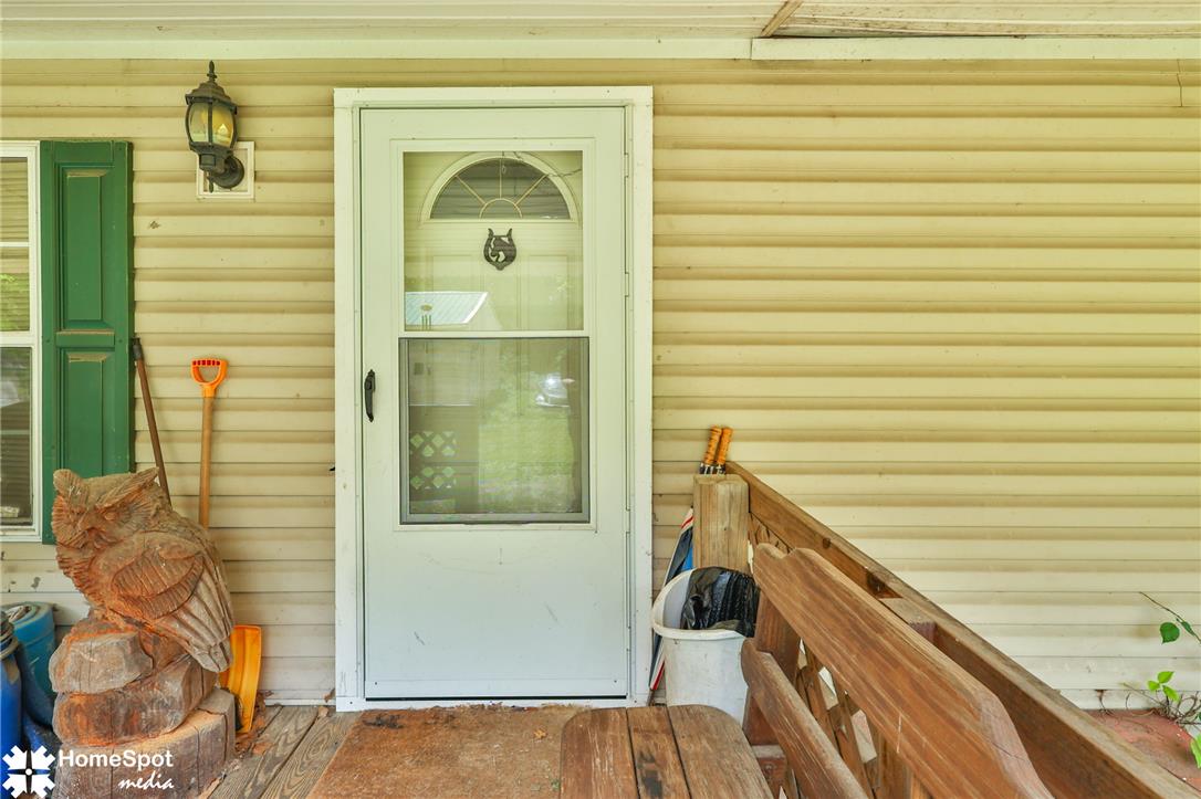 3795 Rhoades Road Kempton, PA 19529 - Photo 8 of 42 A welcoming front porch features classic vinyl siding and a charming storm door.