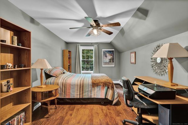 a bedroom with furniture and a window