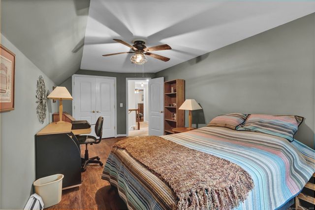 a bedroom with a large bed and a chandelier
