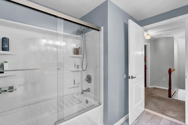 a bathroom with a glass shower door