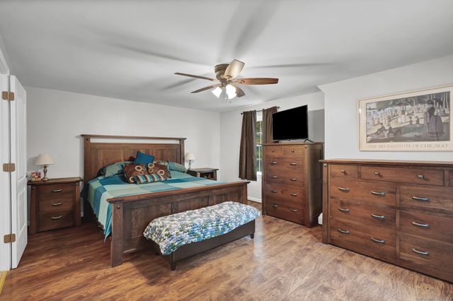 a bedroom with a bed and a television