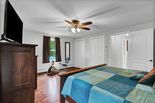 a bedroom with bed and flat screen tv