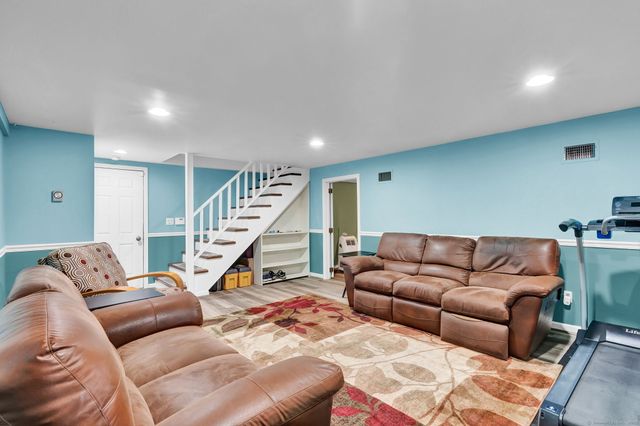 a living room with furniture and stairs