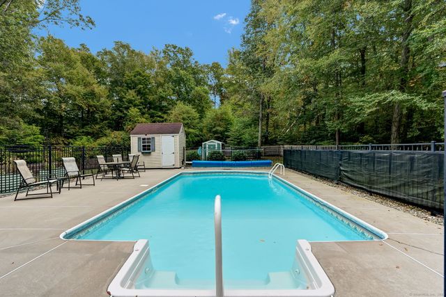 a view of a swimming pool with chairs