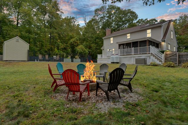 a view of a chairs in backyard of house