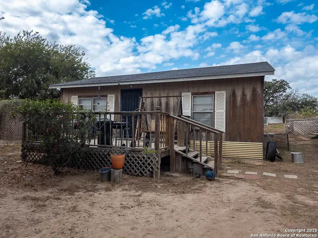 a view of house with backyard and deck