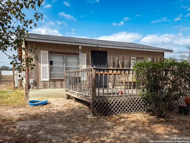 a view of a house with wooden fence