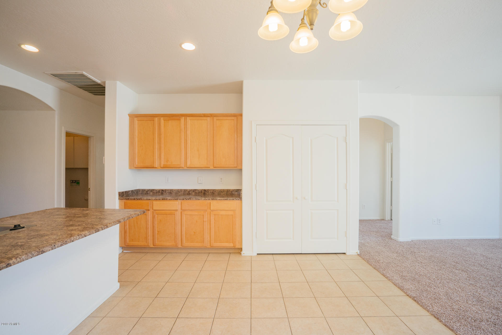 14241 West Calavar Road Surprise, AZ 85379 - Photo 8 of 26 a view of a kitchen with a sink and a living room