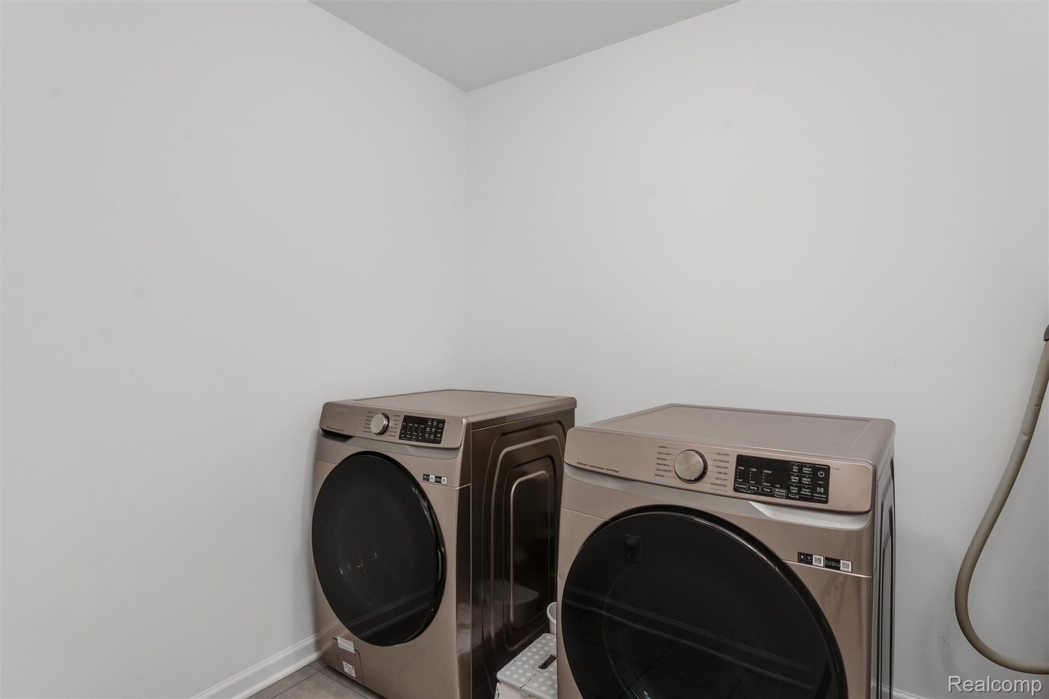 908 South Livernois Road Rochester, MI 48309 - Photo 35 of 49 Laundry area with washer and clothes dryer and baseboards