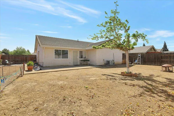 a view of a house with backyard and sitting area