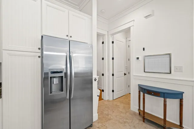 a kitchen with stainless steel appliances a refrigerator sink and cabinets
