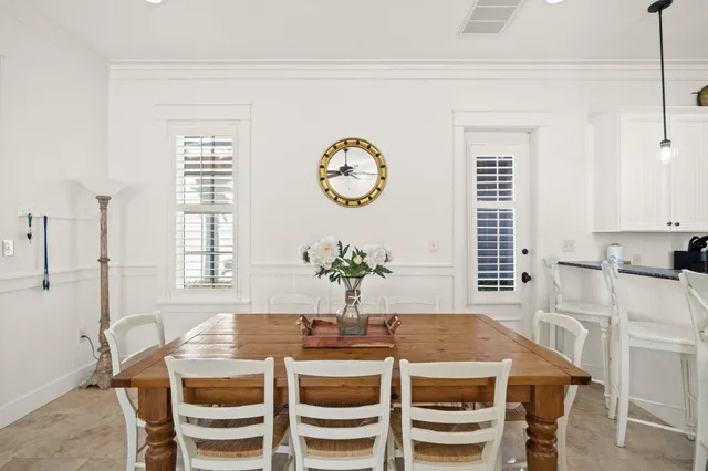 a view of a dining room with furniture and chandelier