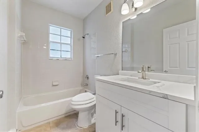 a bathroom with a sink a toilet and bathtub