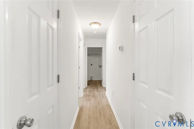 a view of a hallway with wooden floor