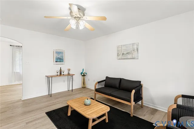 a living room with furniture and wooden floor