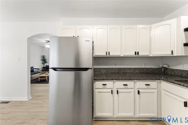 a view of kitchen with granite countertop cabinets and stainless steel appliances