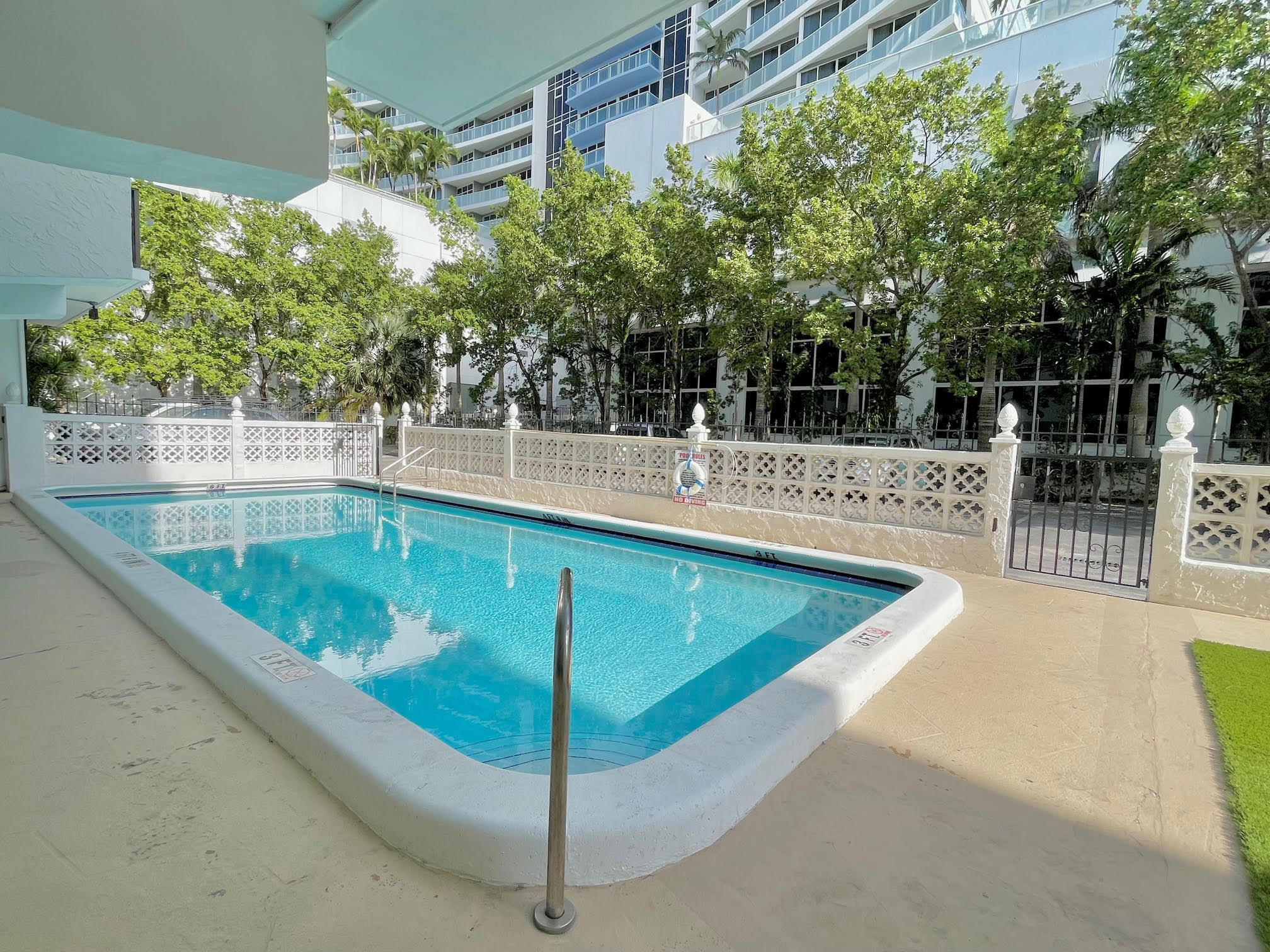 3000 Riomar Street, Unit 407 Fort Lauderdale, FL 33304 - Photo 29 of 38 a view of a swimming pool with a patio and plants