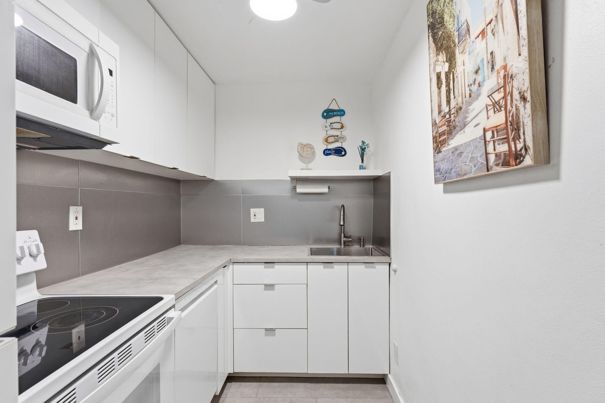 3000 Riomar Street, Unit 407 Fort Lauderdale, FL 33304 - Photo 4 of 38 a kitchen with a sink and cabinets
