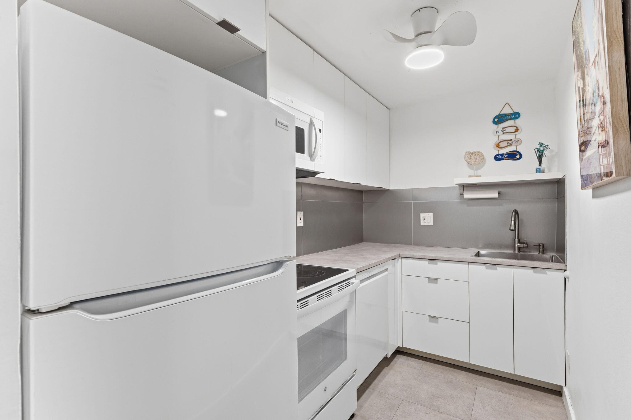 3000 Riomar Street, Unit 407 Fort Lauderdale, FL 33304 - Photo 6 of 38 a kitchen with stainless steel appliances a refrigerator sink and cabinets