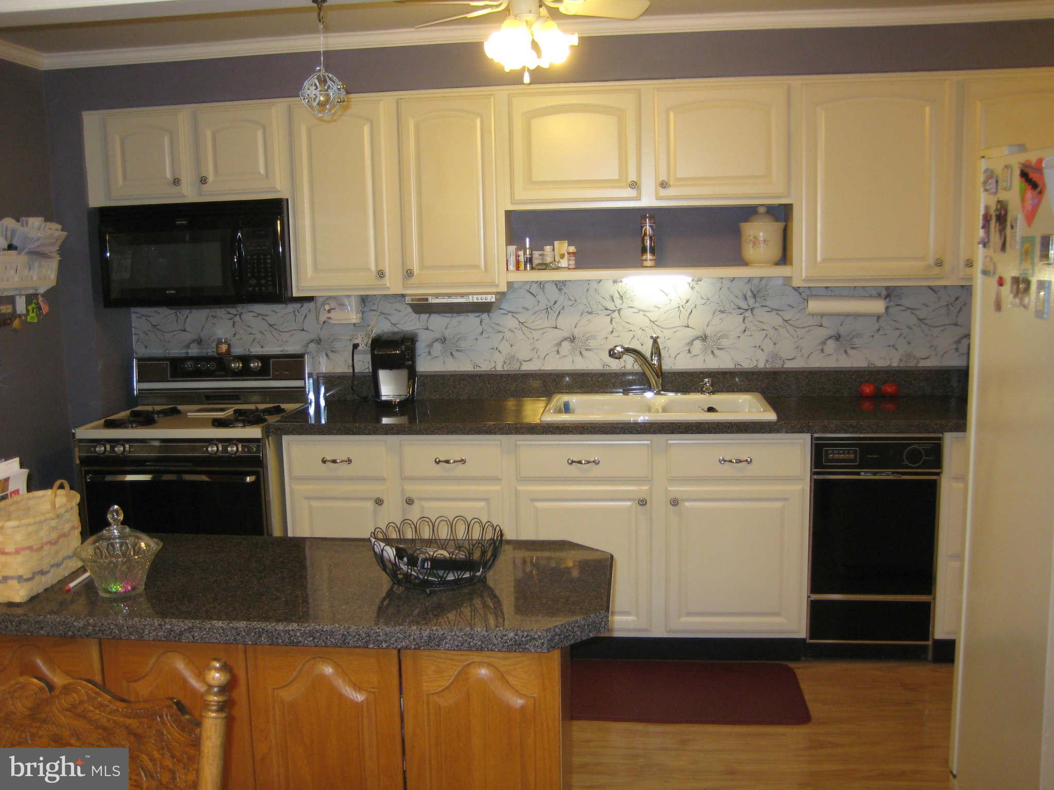 1780 Melbourne Road Baltimore, MD 21222 - Photo 12 of 25 a kitchen with stainless steel appliances granite countertop a sink stove and microwave