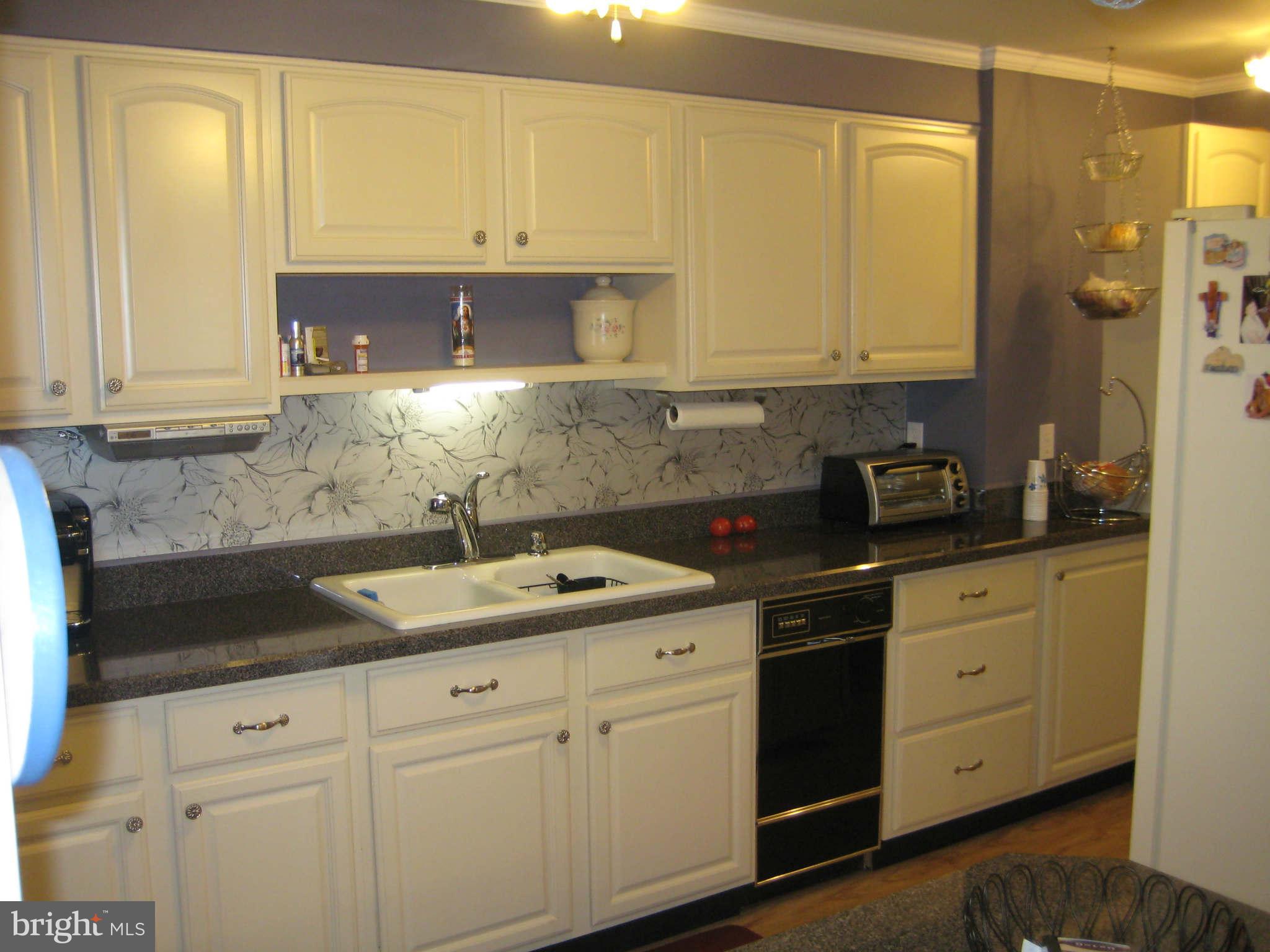 1780 Melbourne Road Baltimore, MD 21222 - Photo 13 of 25 a kitchen with granite countertop white cabinets and white appliances