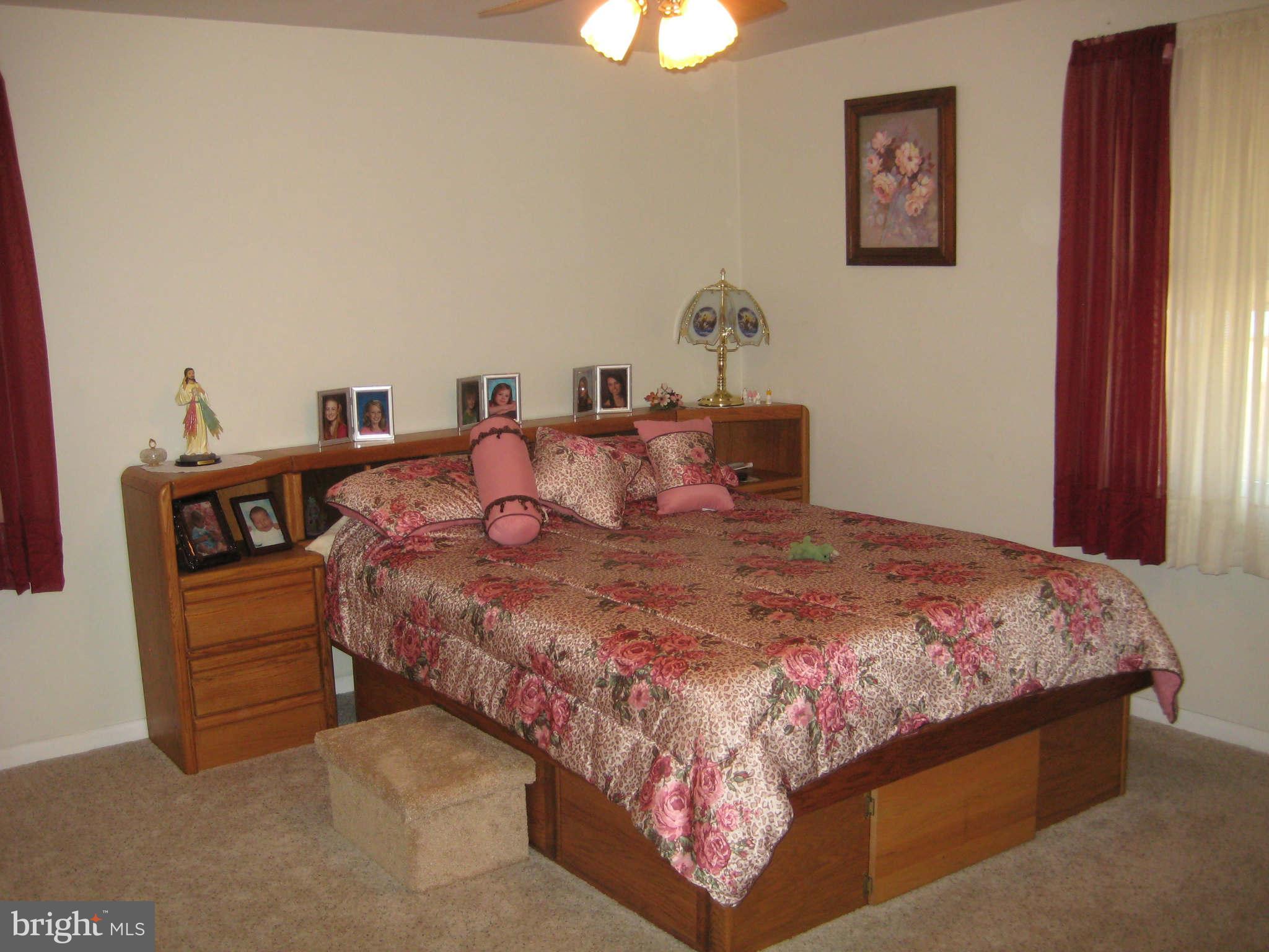 1780 Melbourne Road Baltimore, MD 21222 - Photo 17 of 25 a bedroom with a bed and a chandelier