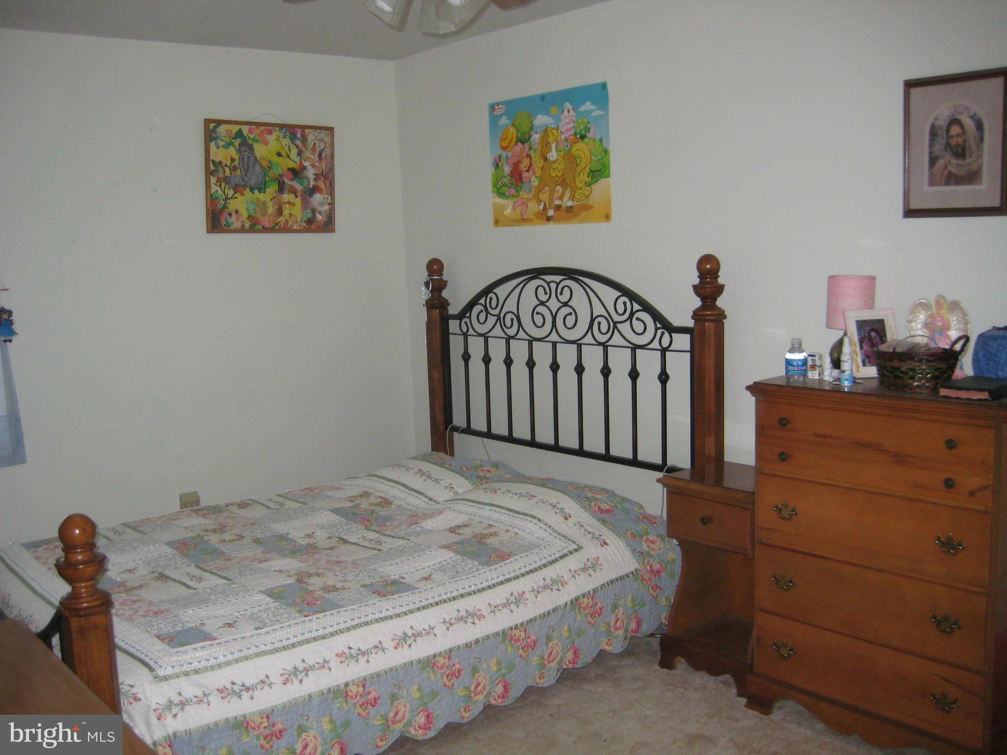 1780 Melbourne Road Baltimore, MD 21222 - Photo 20 of 25 a bedroom with a bed and a dresser