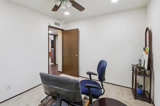 a view of a livingroom with furniture and a ceiling fan