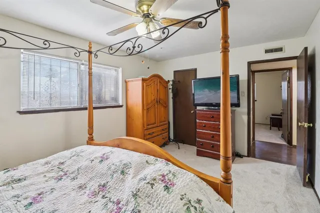 a bedroom with a bed and a mirror