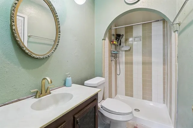a bathroom with a sink a toilet and a mirror