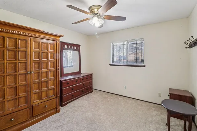 a room with furniture and ceiling fan