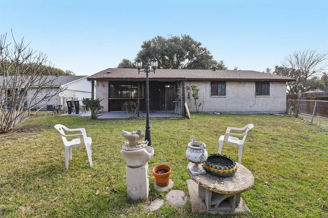 a front view of a house with patio furniture and a yard