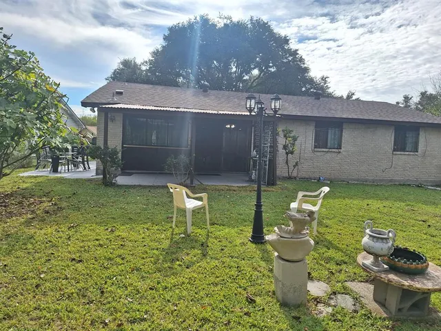 a view of an house with backyard space and garden