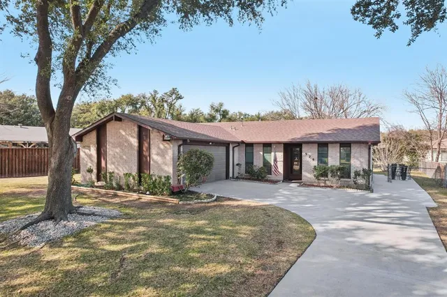 a front view of a house with a garden and patio
