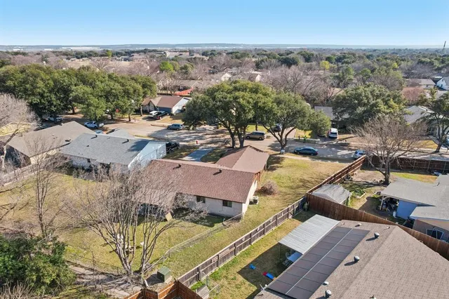 an aerial view of a house with a yard