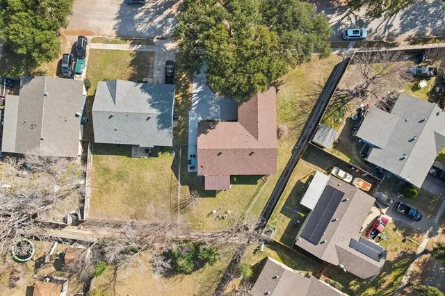 an aerial view of a house with a yard