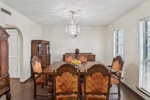 a view of a dining room with furniture and chandelier