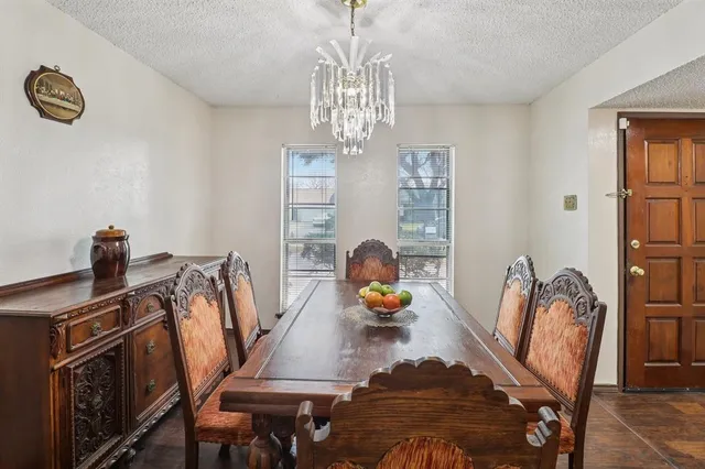 a view of a dining room with furniture and chandelier