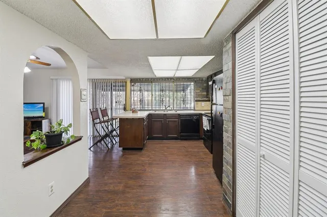 a view of a kitchen with a sink and cabinets