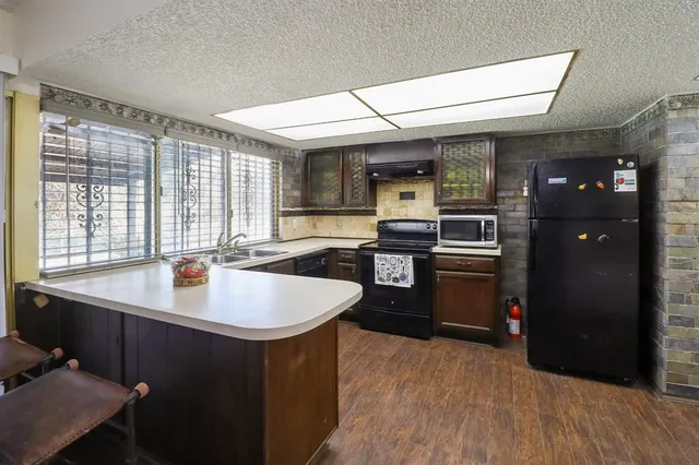 a kitchen with sink cabinets and window